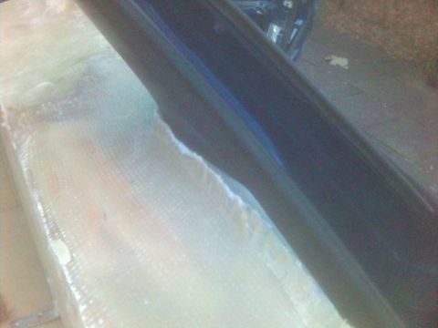 1994 Ford Probe - A car part is being worked on with fiberglass material. The SuperMotors logo is visible in the corner.