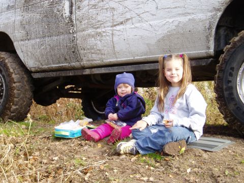 2000 Ford E350 - Two young children enjoy a picnic lunch next to a heavily mud-caked van.