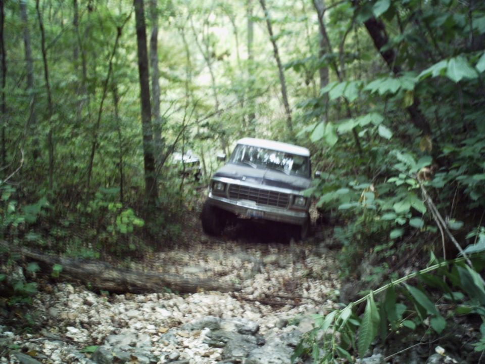 1980s Ford Bronco on wooded trail