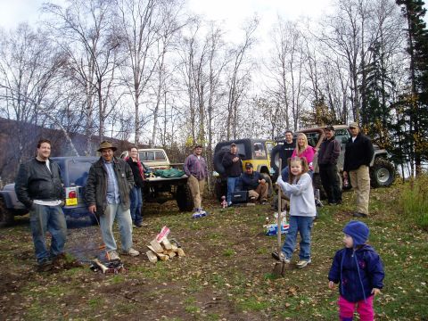2000 Ford E350 - People and off-road vehicles in a wooded area, possibly a gathering or camping trip.