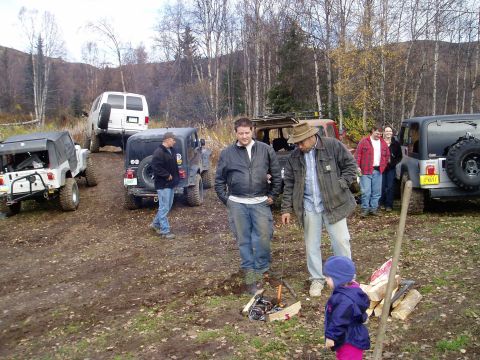 2000 Ford E350 - Off-road vehicles and people gathered in a wooded area during the fall.