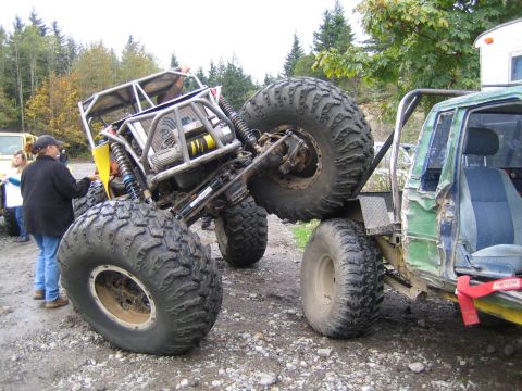 1990 Ford Bronco - Modified off-road vehicles are shown in a challenging outdoor environment.