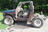 1987 Suzuki Samurai - This Suzuki Samurai is missing its doors and top, showing its interior and frame.