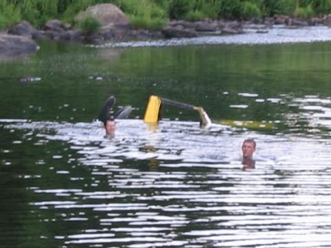 1987 Suzuki Samurai - People swim in a river, with a yellow object visible in the water.