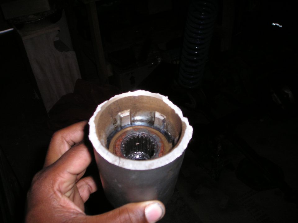 Hand holding a metal tube showing a splined hub inside