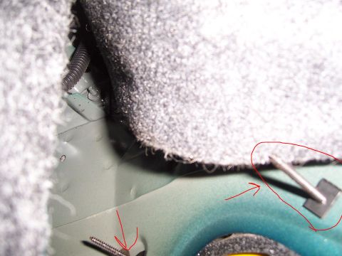 1996 Mercury Sable - Close-up view of the car's interior floor, showing carpet trim and exposed metal components.