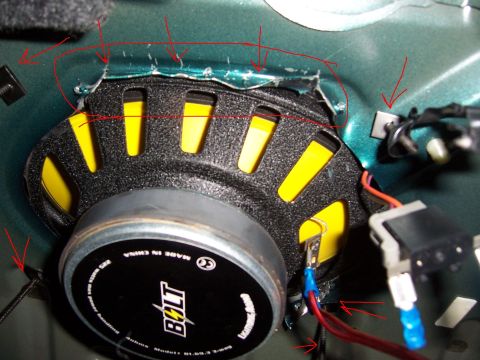 1996 Mercury Sable - Close-up of a car door speaker installation, showing wiring and mounting points.