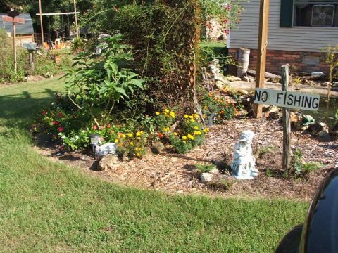 1966 Ford Ranchero - A yard scene a garden, a statue, and a sign prohibiting fishing.