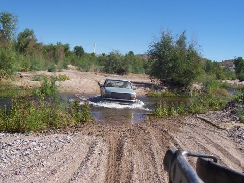 1996 Ford Bronco - A 1992 Ford F-150 navigates a water crossing on a dirt road.