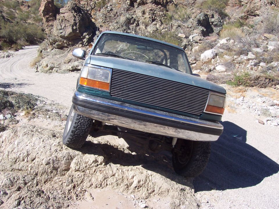 Teal Ford Explorer on a rocky trail