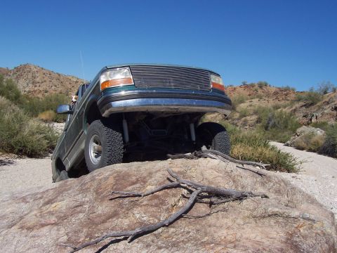 1996 Ford Bronco - This 1996 Ford Bronco is navigating a rocky obstacle in a desert environment.