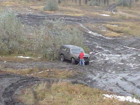 1981 Ford Bronco - Heres where I was stuck in a rut in the front across both tires. Im jacking it up to put some wood under the tires.