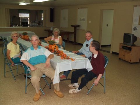 1966 Ford Ranchero - A group of people are seated at tables set up for a gathering, with fall decorations including pumpkins and leaves.