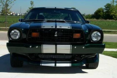 1978 Ford Mustang II - This Mustang II features a prominent grille and dual headlights, with racing stripes on the hood and body.
