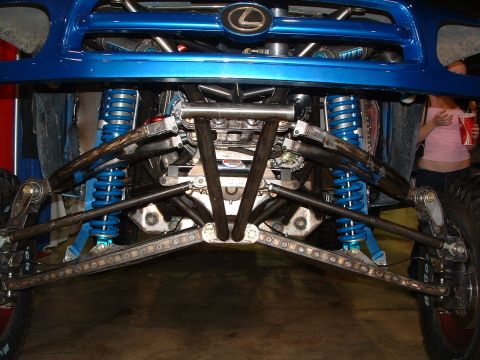 2004 Toyota Tacoma - Customized Lexus front suspension system with blue coilover shocks and off-road tires.