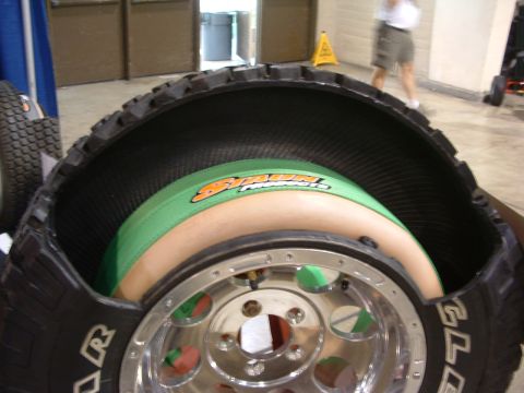 2004 Toyota Tacoma - A tire has been cut open to reveal an inner tube and wheel assembly inside.