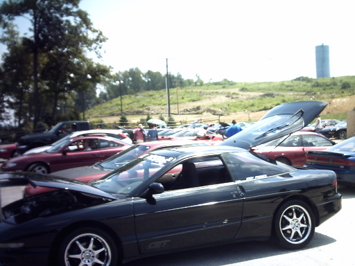 Black Ford Probe GT with hood and trunk open, parked outdoors