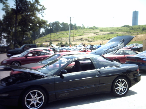 Black 1995 Ford Probe GT with hood open, parked in a lot with other cars