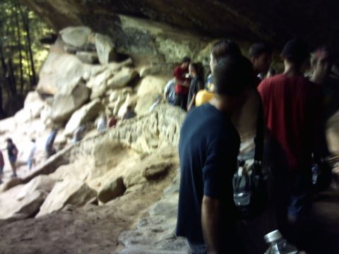 1995 Ford Probe - A group of individuals are exploring a natural cave formation.
