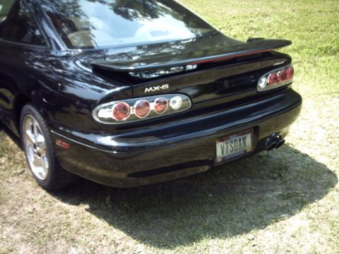 1995 Ford Probe - Rear view of a black Mazda MX-6, identifiable by its 'MX-6' badging and distinctive taillights.