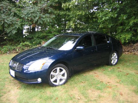 2005 Nissan Maxima - Dark blue sedan parked on grass. The body style indicates a 2004 model year.