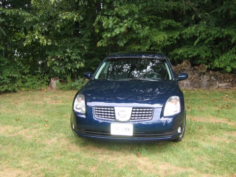 2005 Nissan Maxima - Front view of a dark blue sedan with a chrome grille and a sunroof.