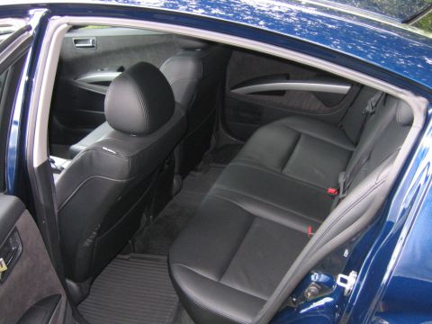 2005 Nissan Maxima - Rear interior view of a blue 2005 Nissan Maxima, showing black leather seats and door panels.