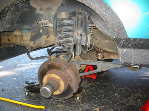 1996 Ford Bronco - Close-up of the rear suspension and brake assembly of a 1996 Ford Bronco, showing the shock, coil spring, and brake rotor.