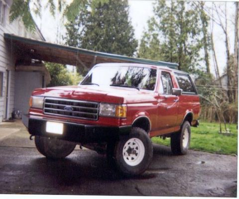 1989 Ford Bronco - This red 1989 Ford Bronco is shown from the front quarter angle.