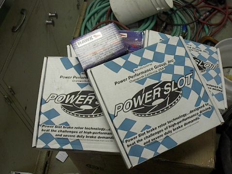 1993 Ford Probe - Several boxes of Power Slot brake rotors and Hawk brake pads are stacked together.