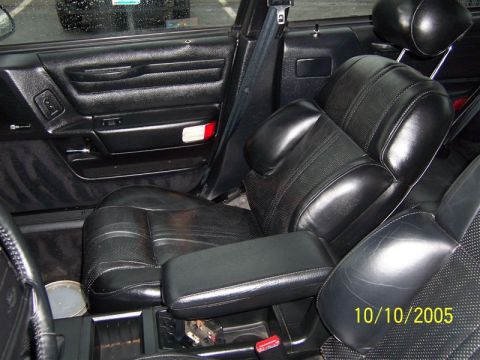 1997 Ford Taurus - The interior of a car shows black leather seats and door panels, with a date stamp from 2005.