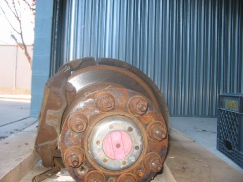 1991 Ford Bronco - Close-up of a rusty brake rotor and hub assembly, likely from a truck or SUV.
