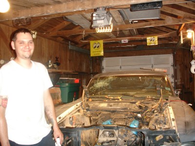 1972 Ford Ranchero - A man stands next to a 1972 Ford Ranchero in a garage, its engine compartment exposed.