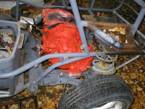 2003 Jeep TJ - The frame and engine of a custom vehicle are shown, with parts scattered around and the vehicle in a state of disrepair.