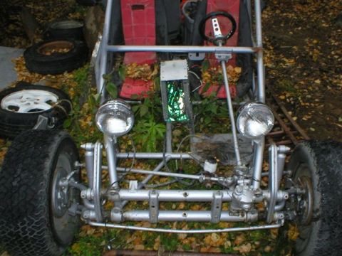 2003 Jeep TJ - This custom buggy features a bare metal frame, exposed suspension components, and red bucket seats, suggesting it is built for off-road use.