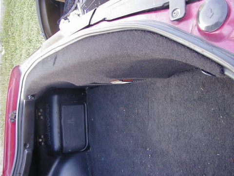 1994 Ford Probe - Trunk interior with a subwoofer enclosure visible on the left side.