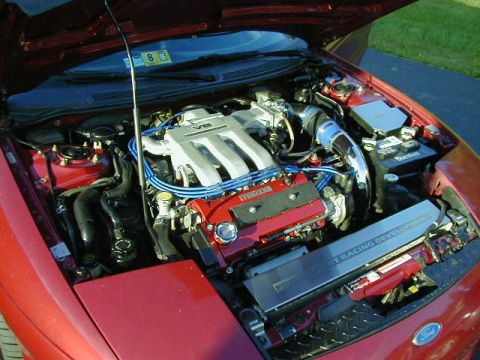 1994 Ford Probe - Engine bay of a Mazda V6, showing aftermarket parts and custom engine covers.
