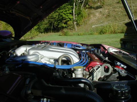 1994 Ford Probe - Close-up view of a car's engine bay, showing various components and a watermark at the bottom right.