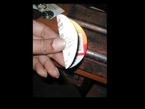 1979 Ford Bronco - A label with text and a barcode is held by a hand.