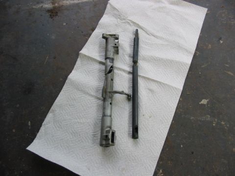 1997 Ford Crown Victoria - Two disassembled metal components are shown on a textured surface, possibly for repair or replacement.