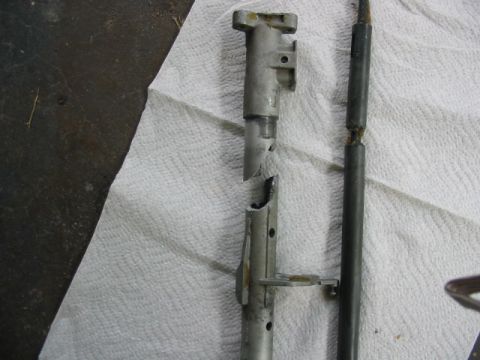 1997 Ford Crown Victoria - A broken metal component and rod are shown on a paper towel, with a website address visible.