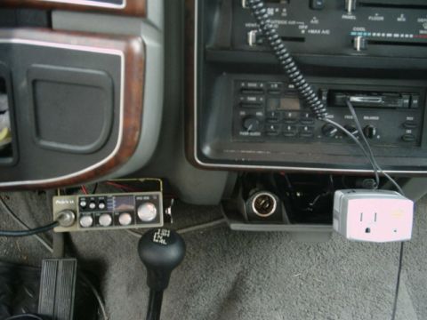 1988 Ford Bronco - Aftermarket CB radio and power inverter installed in the dashboard area of a vehicle.