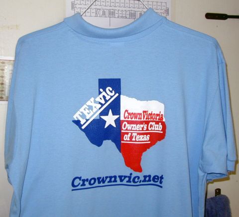 2000 Ford Crown Victoria - A light blue t-shirt displays a graphic of the state of Texas with club information.