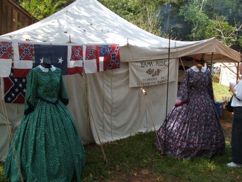1966 Ford Ranchero - Civil War reenactment display features historical dresses and flags under a tent.
