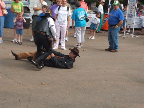 1966 Ford Ranchero - A staged scene depicts a cowboy on the ground being apprehended by another cowboy.