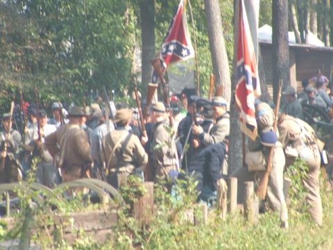 1966 Ford Ranchero - A group of people dressed as Civil War soldiers stand with rifles and flags in a wooded area.