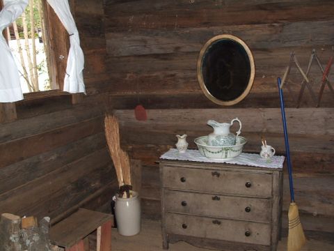 1966 Ford Ranchero - A vintage wash basin and pitcher sit atop a dresser in a room with log walls.
