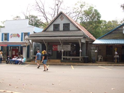 1966 Ford Ranchero - A quaint general store scene with people gathered outside and a vintage Coca-Cola advertisement visible.