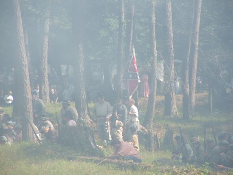 1966 Ford Ranchero - A Civil War reenactment unfolds in a wooded area, soldiers and a Confederate flag.