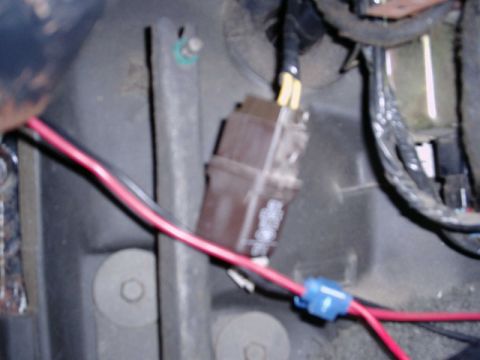 1988 Ford Bronco - Close-up of a brown factory horn relay mounted to the black inner fender panel in an engine bay, with yellow spade terminals plugged into i…